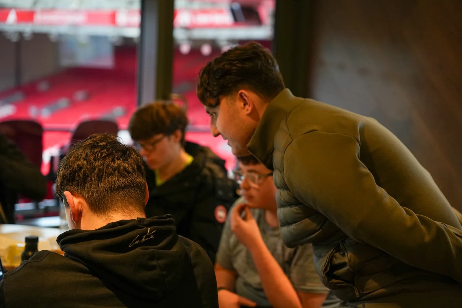 Joseph Roberts working with students around a table during a workshop