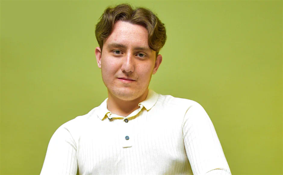 Studio portrait of Joseph Roberts against a bright green background