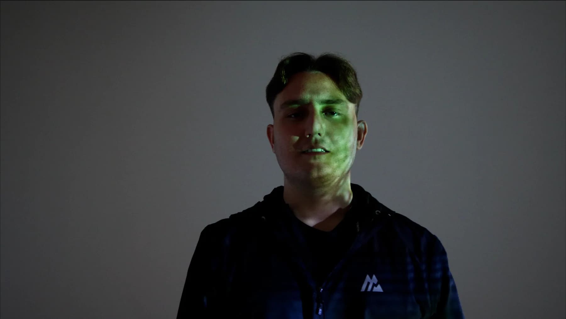 Joseph Roberts in a dark Montirex jacket against a green-lit background
