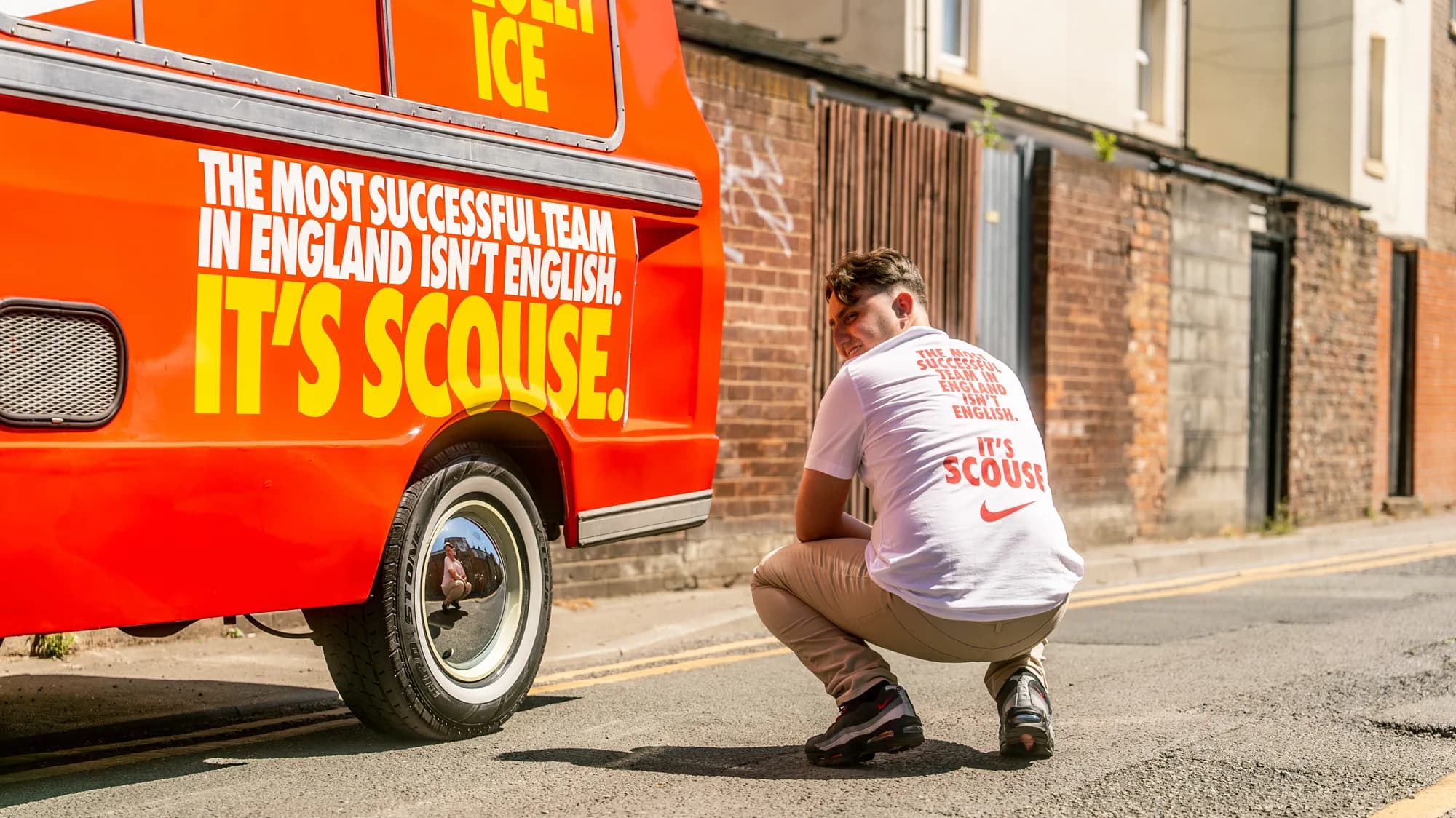 Joseph Roberts wearing the campaign shirt beside the Nike Liverpool FC van